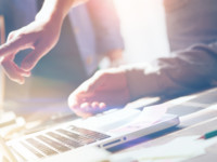 People pointing at laptop