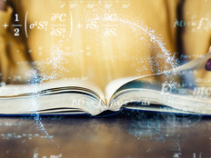 A woman flips through a textbook