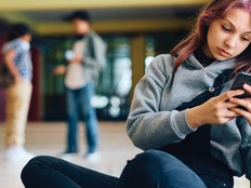 Student using phone in hallway