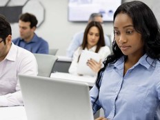 Students working on laptops in class
