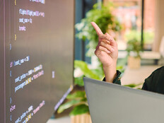 Person analyzing code on laptop