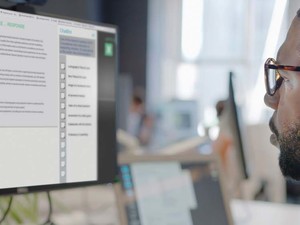 A man looks at a generative AI platform on a computer screen
