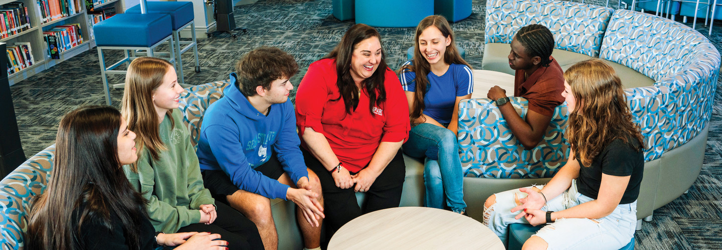 Kerri Wall, Senior Instructional Technology Administrator and Data Privacy Compliance Officer for the School District of Indian River County, works with students in a new collaborative library space.