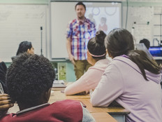 Teacher lecturing K-12 students