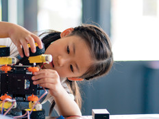 K–12 student building a robot with wheels